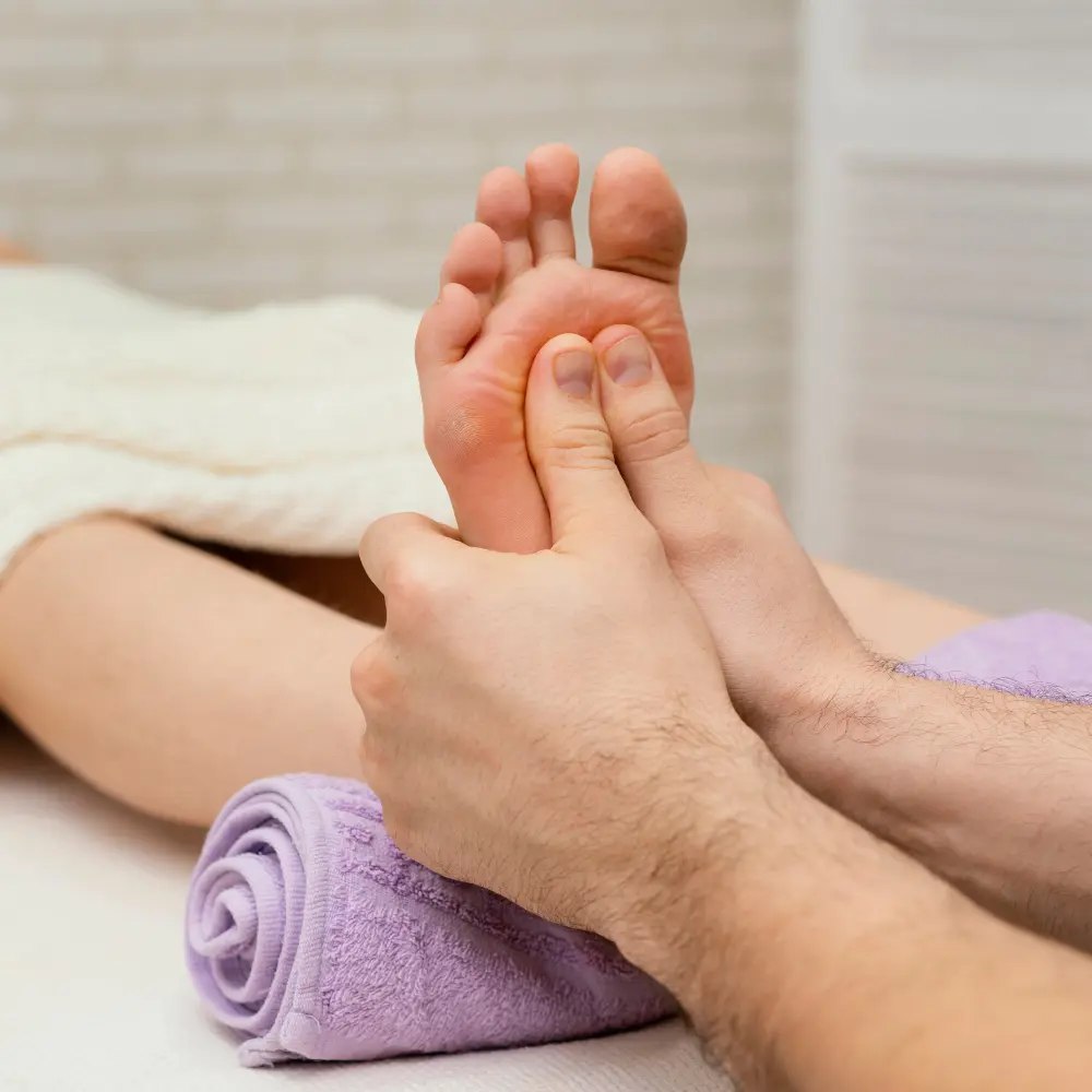 Foot reflexology treatment focusing on pressure points