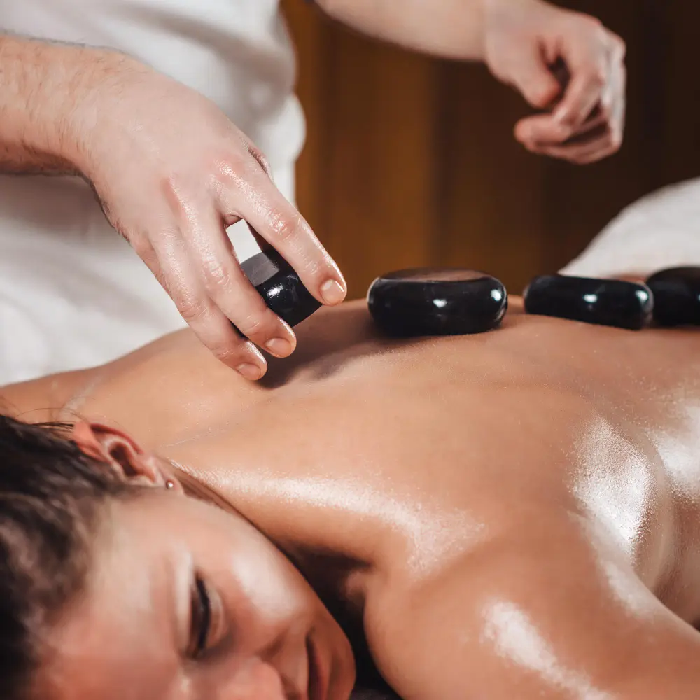 Hot stone massage treatment with heated stones on the back